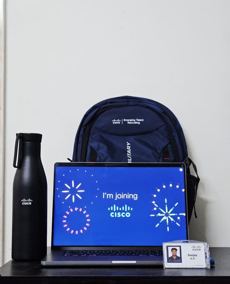 Cisco welcome kit beside a laptop displaying I'm joining Cisco.