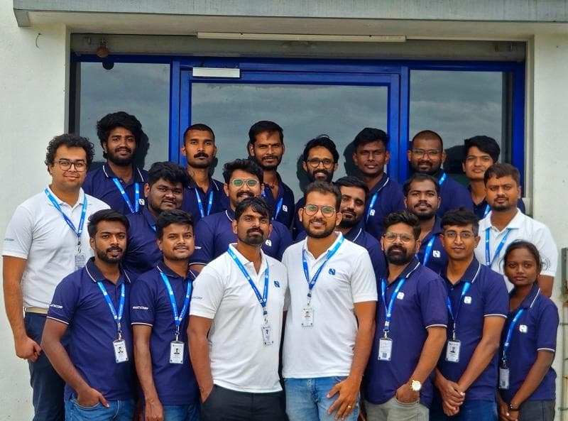 Naatscorp team posing together outside the office.