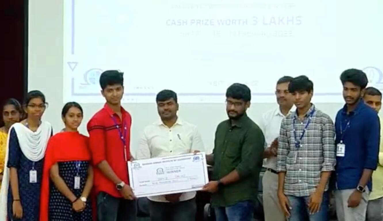 A student team receives a winner cheque at an award ceremony.