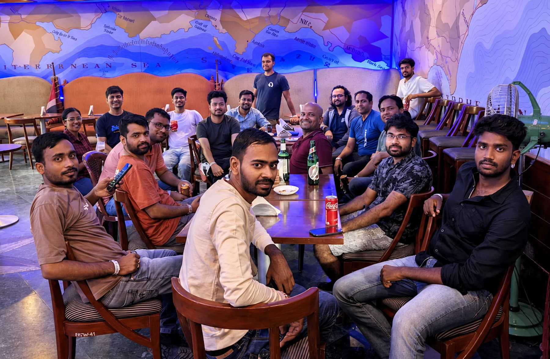 Cisco colleagues seated together around tables during a team gathering.